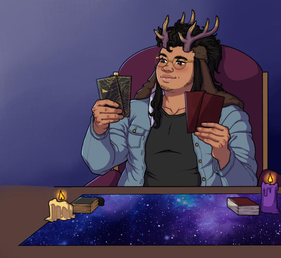 A man with antlers and floppy brown ears sits at a desk with tarot cards in both hands and tarot decks on the table, as well as lit candle, against a dark blue gradient background.