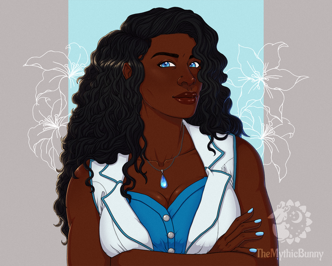 A dark skinned woman with long black curly hair and blue eyes is poised in a portrait. She wears a blue sparkling pendant necklace on a silver chain and wears a white and blue vest.